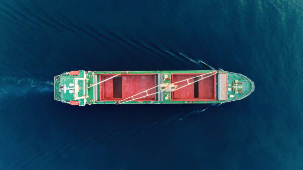 istock Aerial view empty container ship to sea port and working crane bridge loading container for import  export or transportation concept background. 1066766268