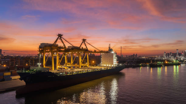 istock Container ship to sea port and working crane bridge loading container with beautiful sky for import  export or transportation concept background. 1066766744