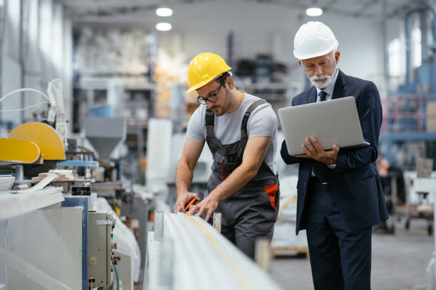istock Young engineer with quality control inspector in factory 1066792836