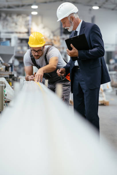 istock Young engineer with quality control inspector in factory 1066794262