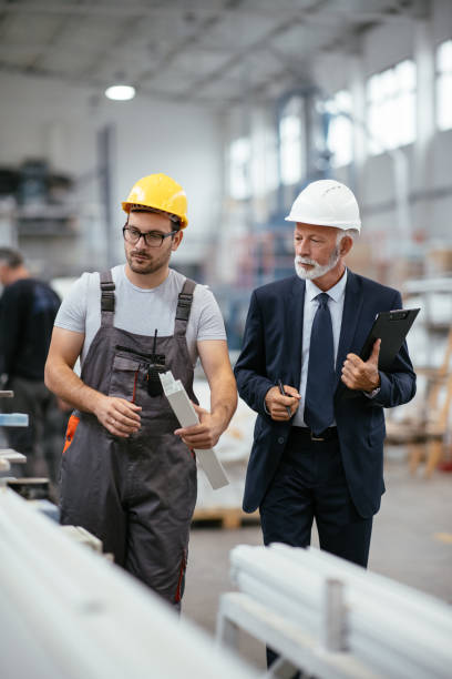 istock Young engineer with quality control inspector in factory 1066798000