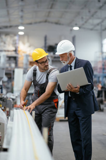 istock Young engineer with quality control inspector in factory 1066798284