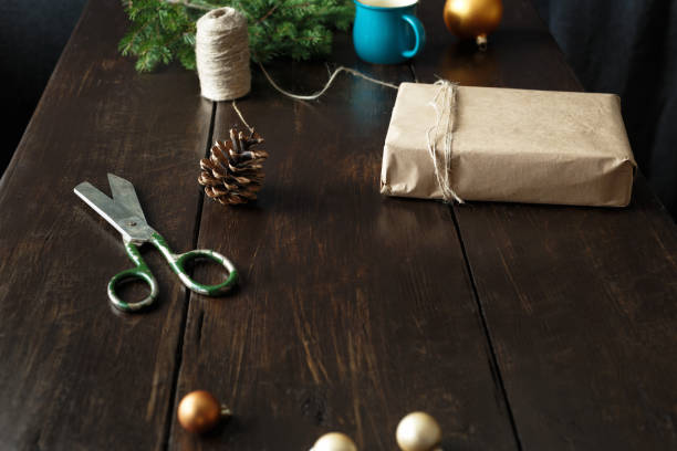 istock Christmas ornaments gift boxes wooden table Rustic Christmas background Wrapping presents 1066802320
