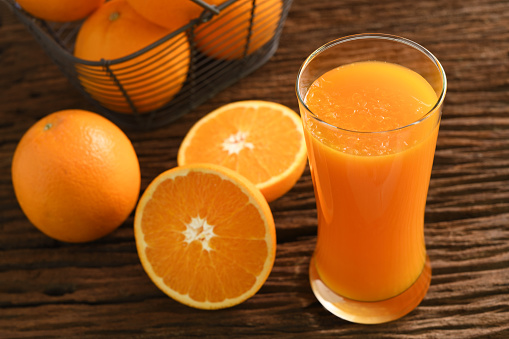 Tangerine, directly above a whole peeled tangerine mandarin on the gray granite stone background with copy space