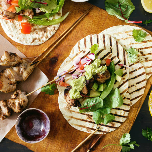 istock Dinner table with tacos grill with vegetable salsa, guacamole sauce, chicken 1066804382