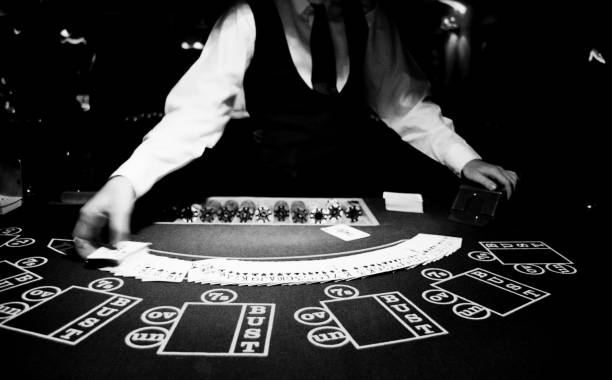 Croupier shuffles cards at a casino stock photo