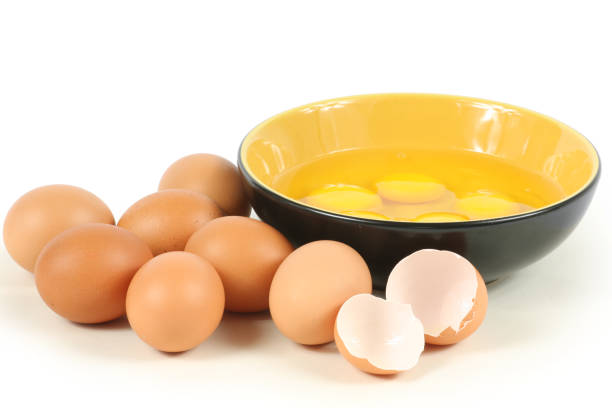 istock Hen egg, eggshell and Raw egg yolk in bowl  closeup isolated on white background 1066815026