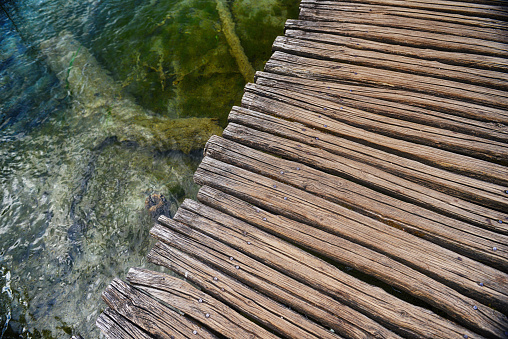 Wooden bridge  for crossing over an  water surface of lakes