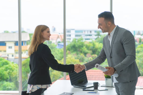 istock business woman with confidence handshake with partner 1066831076