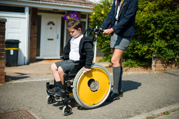 istock Boy pushing his brother in a wheelchair 1066837946