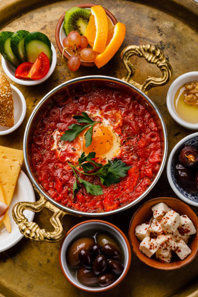 istock Fried egg with tomatoes in copper pan and various snacks for Breakfast on copper tray 1066838350