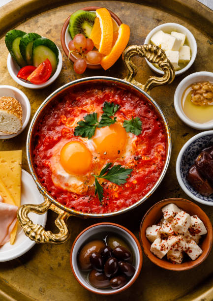istock Fried egg with tomatoes in copper pan and various snacks for Breakfast on copper tray 1066838364