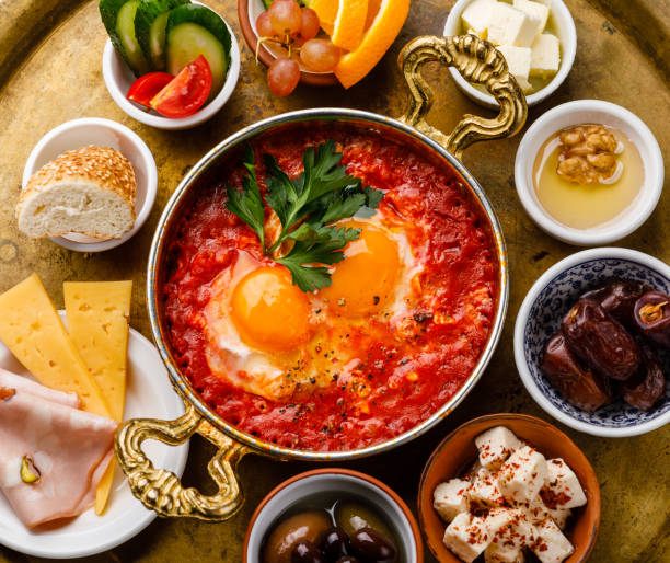 istock Fried egg with tomatoes in copper pan and various snacks for Breakfast on copper tray 1066840254