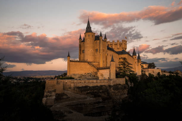 Castelbuono, Sicily, Italy - April 30, 2014: The 14th-century Norman-Arab castle of Castelbuono rising toward the clouds. Castelbuono is in Palermo Province.