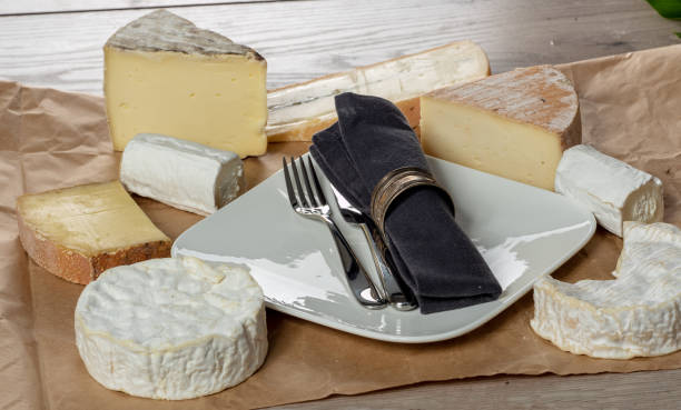 istock several french cheeses with a plate and cutlery 1066844514