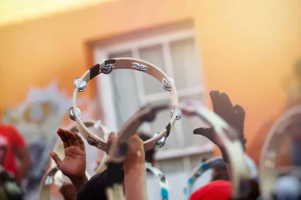 Tambourines held high during a street Carnival parade Kaapse Klopse Cape Malay Quarters Cape Town