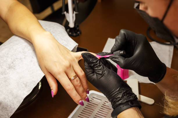 istock professional master of manicure makes the nails to the client. 1066861286