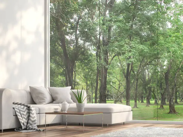 Photo of Minimal sofa located at the window with garden view 3d render