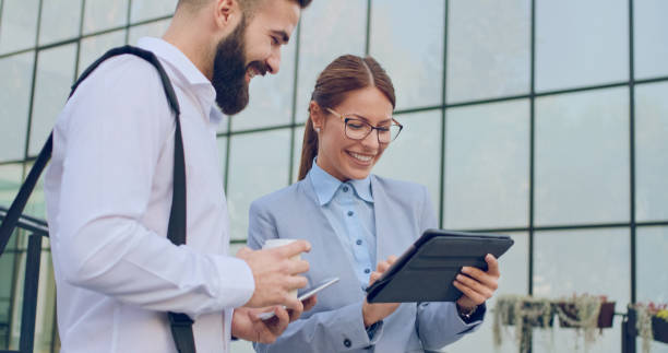 istock Male and female business people browsing on tablet computer 1066866150