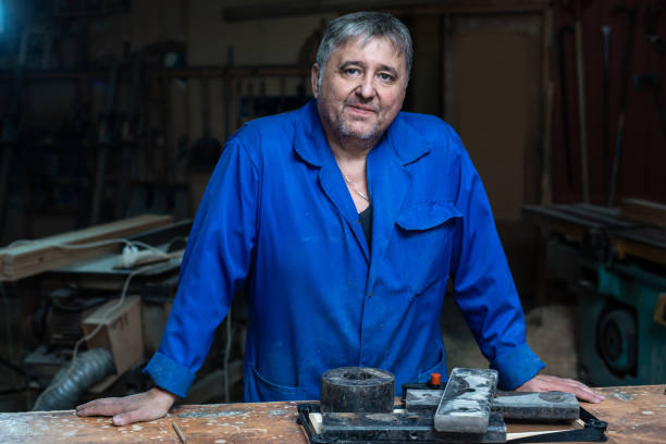 istock Mature carpenter approaches the camera and stands in a confident pose in his workshop 1066866680