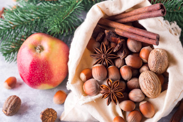 istock Hazelnuts and walnuts, apples and cinnamon. Ingredients for Christmas baking. Top view, stone background, 1066868228