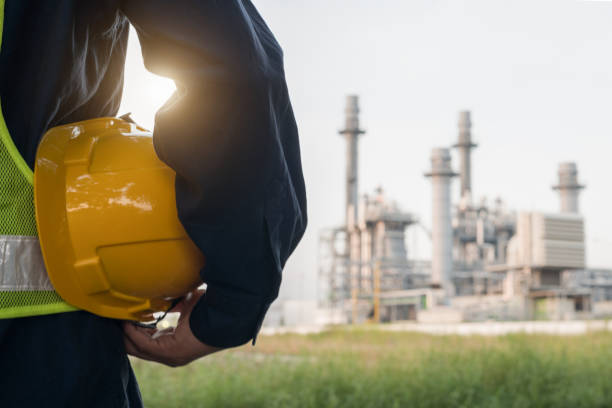 istock engineering man with white safety helmet standing in front of oil refinery building structure in heavy petrochemical industry 1066868520
