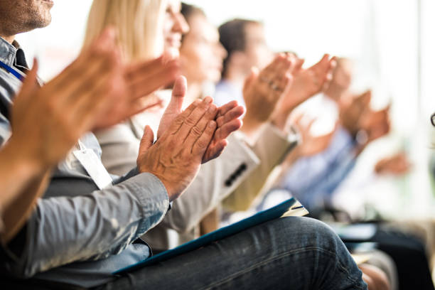 Applauding on a business seminar! Large group of unrecognizable business people applauding in board room. Focus is on man's hands. clapping photos stock pictures, royalty-free photos & images