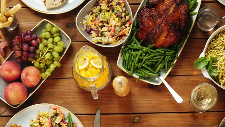 group of people eating at table with food