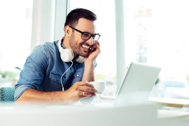 istock Happy man drinking coffee and looking at his laptop. 1066871156