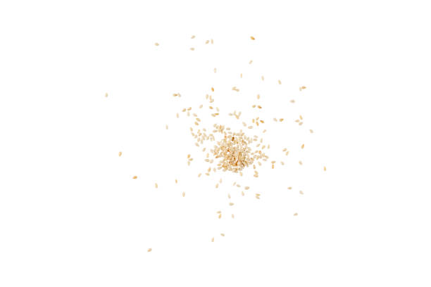 istock A scattering of white sesame seeds on a white background. 1066877562