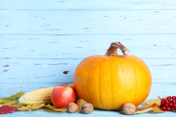 istock Orange pumpkin with leaves on a blue background. 1066880128