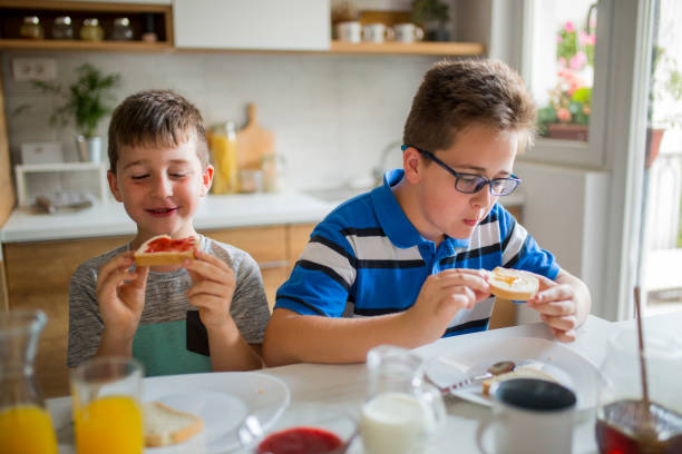 istock Happy kids having healthy breakfast 1066880344