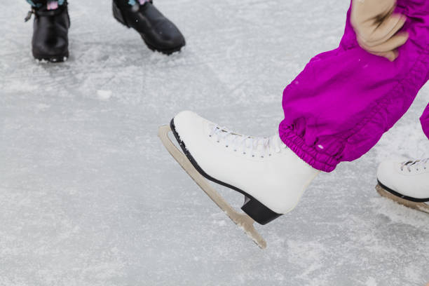 istock Hands hold leather shoes with skates 1066882442