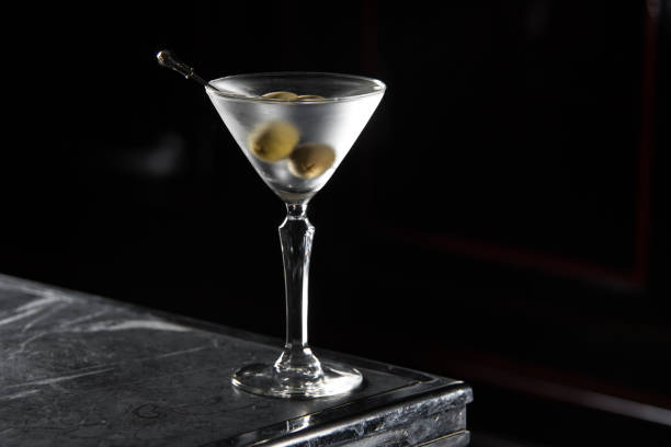 Dry Martini cocktail on a bar desk. black background.