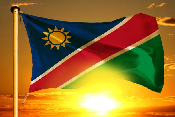 istock Namibia flag weaving on the beautiful orange sunset with clouds background 1066892226