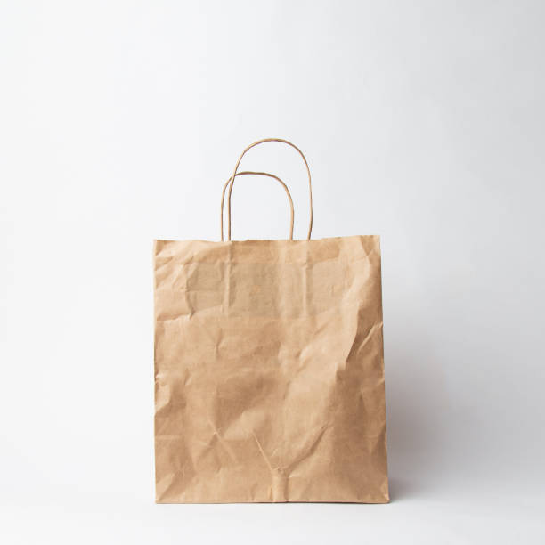 istock Various kraft paper bags and wrapping paper isolated on white background 1066894152