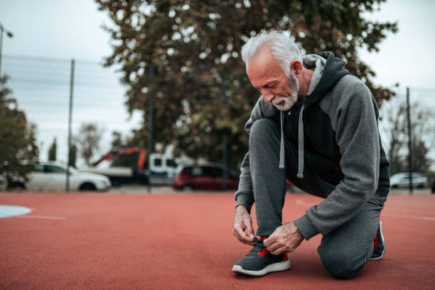 istock Senior man preparing for a run on outdoor stadium. 1066894336