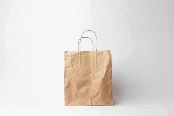 istock Various kraft paper bags and wrapping paper isolated on white background 1066894352