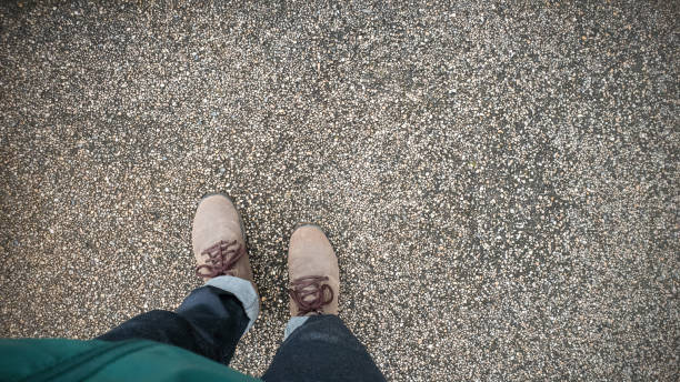 istock A man wearing brown leather boots stands on the floor, Coppy space for your text 1066894458