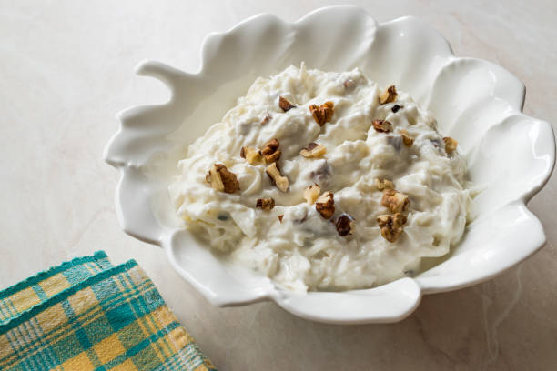 Celery Salad with Yogurt and Walnuts in Leaf Shaped Plate Celery Salad with Yogurt and Walnuts in Leaf Shaped Plate. Organic Food. Celeriac stock pictures, royalty-free photos & images