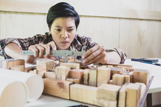 istock Concept architects, Hand of asian young using Vernier caliper equipment architects On the desk with a blueprint in the office. 1066895578