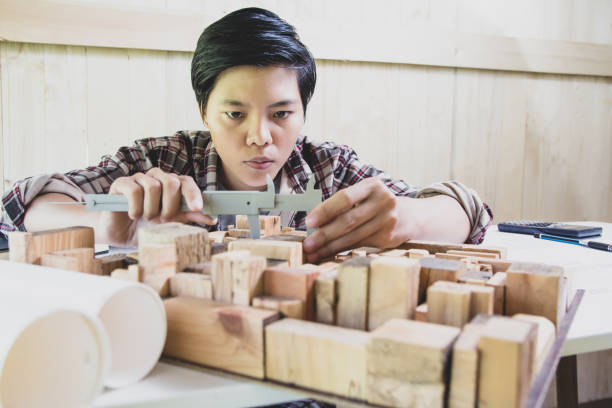 istock Concept architects, Hand of asian young using Vernier caliper equipment architects On the desk with a blueprint in the office. 1066895586