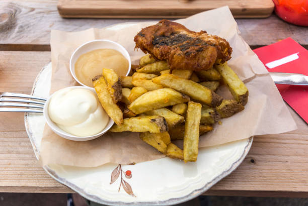 istock Fish and chips served with curry and tartar sauce 1066900508