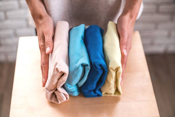 istock Housewife neatly folds a stack of clothes. 1066908732