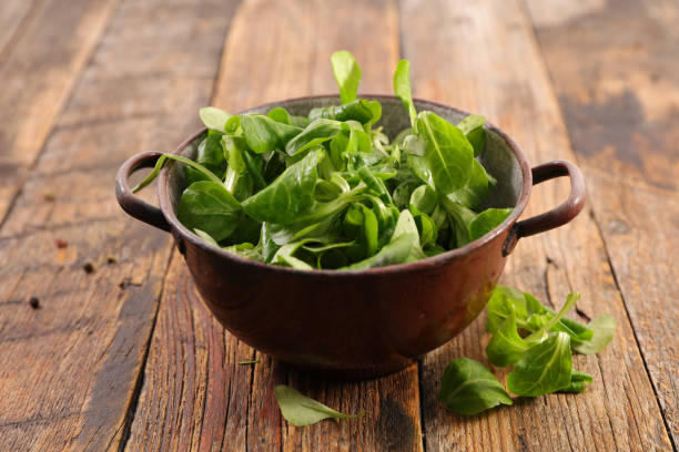 istock green lettuce on wood background 1066908858