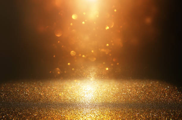 istock glitter vintage lights background. black and gold. de-focused. 1066909266