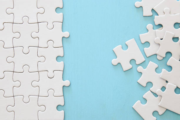 istock background of white puzzle with missing piece. 1066909322