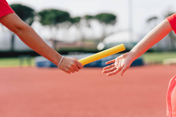 istock Passing the relay baton on the track field 1066909894