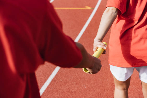 istock Passing the relay baton on the track field 1066909898