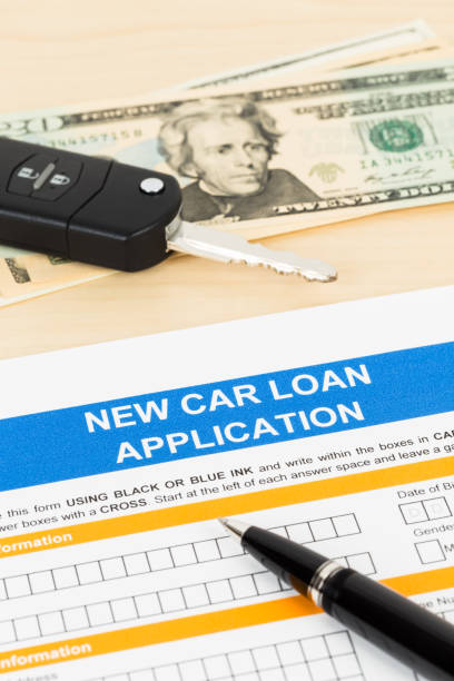 istock Car loan application with car key and dollar banknote; form is mock-up 1066911342